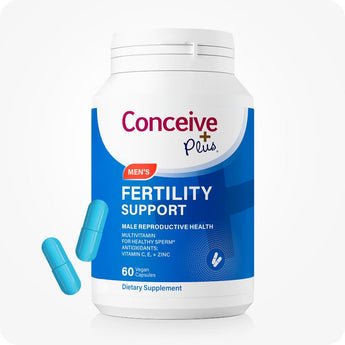 Conceive Plus Men's Fertility Support bottle with blue and white packaging, labeled for male reproductive health support, showing “60 vegan capsules” and highlighting key nutrients like Vitamin C, E, and Zinc; two bright blue capsules are positioned beside bottle on background.