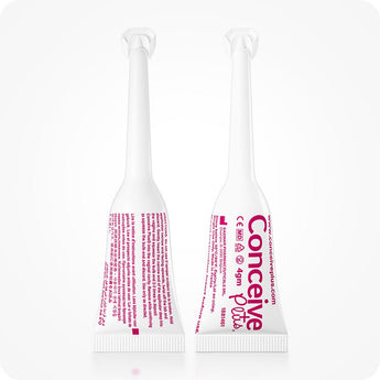 Conceive Plus Fertility Lubricant (8x4g Pre-filled Applicators) close-up of two single-use applicators, one showing front label with branding and dosage, and other displaying back text instructions in fine pink print, both standing upright on a clean white background.